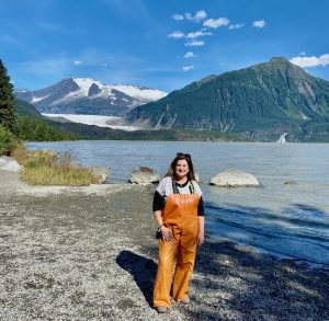 Cindy posing by Mountains, what to expect on an alaskan cruise, Alaska Road Trips