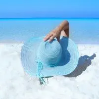 beach lady with hat in blue, A great family vacation on the beach, 3 kids, Relaxing Hamock, Best Excursions in Belize, are Tulum beaches open, best places to dive in Mexico, What to wear to Tulum