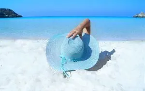 beach lady with hat in blue, A great family vacation on the beach, 3 kids, Relaxing Hamock, Best Excursions in Belize, are Tulum beaches open, best places to dive in Mexico