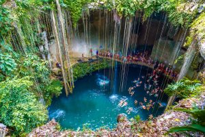 Ik-Kil Cenote Mexico, cenotes caves Mexico, things-that-represent-mexico, beach lady with hat in blue, A great family vacation on the beach, 3 kids, Relaxing Hamock, Best Excursions in Belize, are Tulum beaches open, best cenotes in mexico