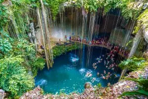 Ik-Kil Cenote Mexico, cenotes caves Mexico, things-that-represent-mexico, beach lady with hat in blue, A great family vacation on the beach, 3 kids, Relaxing Hamock, Best Excursions in Belize, are Tulum beaches open, best cenotes in Mexico,religion, famous things in Mexico, Cancun travel tips