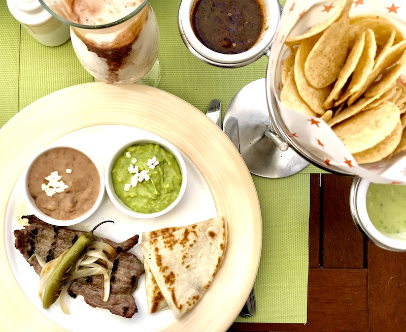 mexican food, blue and white bowl in yellow:white tube, best place for family vacation in mexico