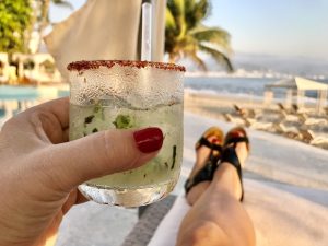 drink in hand at Banderas bay Puerto Vallarta, unique things to do in Puerto Vallarta