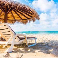 Best 7 Beaches Towns For Expats In Mexico, Umbrella and chair on the beach, downtown Cancun nightlife, nightlife in Cancun, hidden beaches Mexico, best time to cruise to Mexico, best airport for Tulum