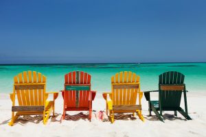 Colorful chairs on Caribbean beach, day trip from st martin to anguilla 