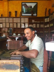 young man rolling a cuban cigar, all inclusive trips to Dominican Republic, best restaurants in Cuba