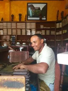 young man rolling a cuban cigar, all inclusive trips to Dominican Republic