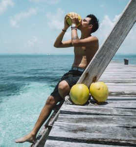 man sipping coconuts, hidden beaches Mexico