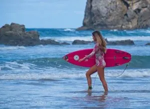 surfer in pink, beginner surf spots san diego